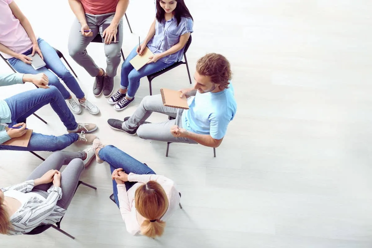 Groupe assis en cercle discussion.